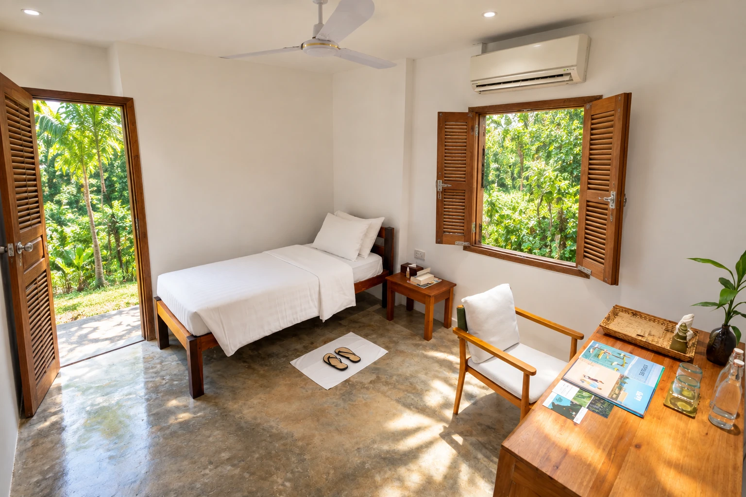A bedroom at the artist residency, with shuttered windows open to the garden