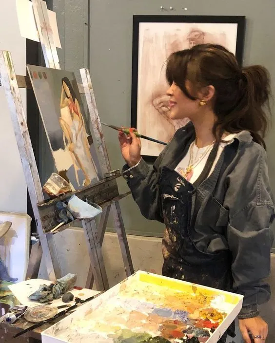 An artist painting in a studio