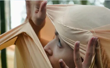 A performer wrapped in fabric, from Rita Lirea’s performance