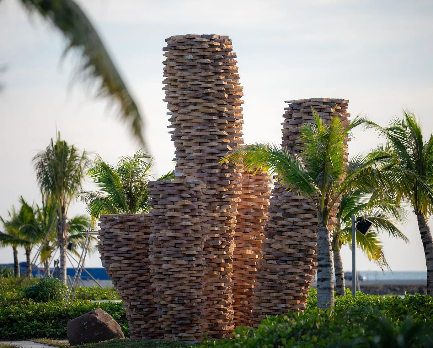 Coral Kingdom, stacked sandstone towers among palm trees on the Kep coast